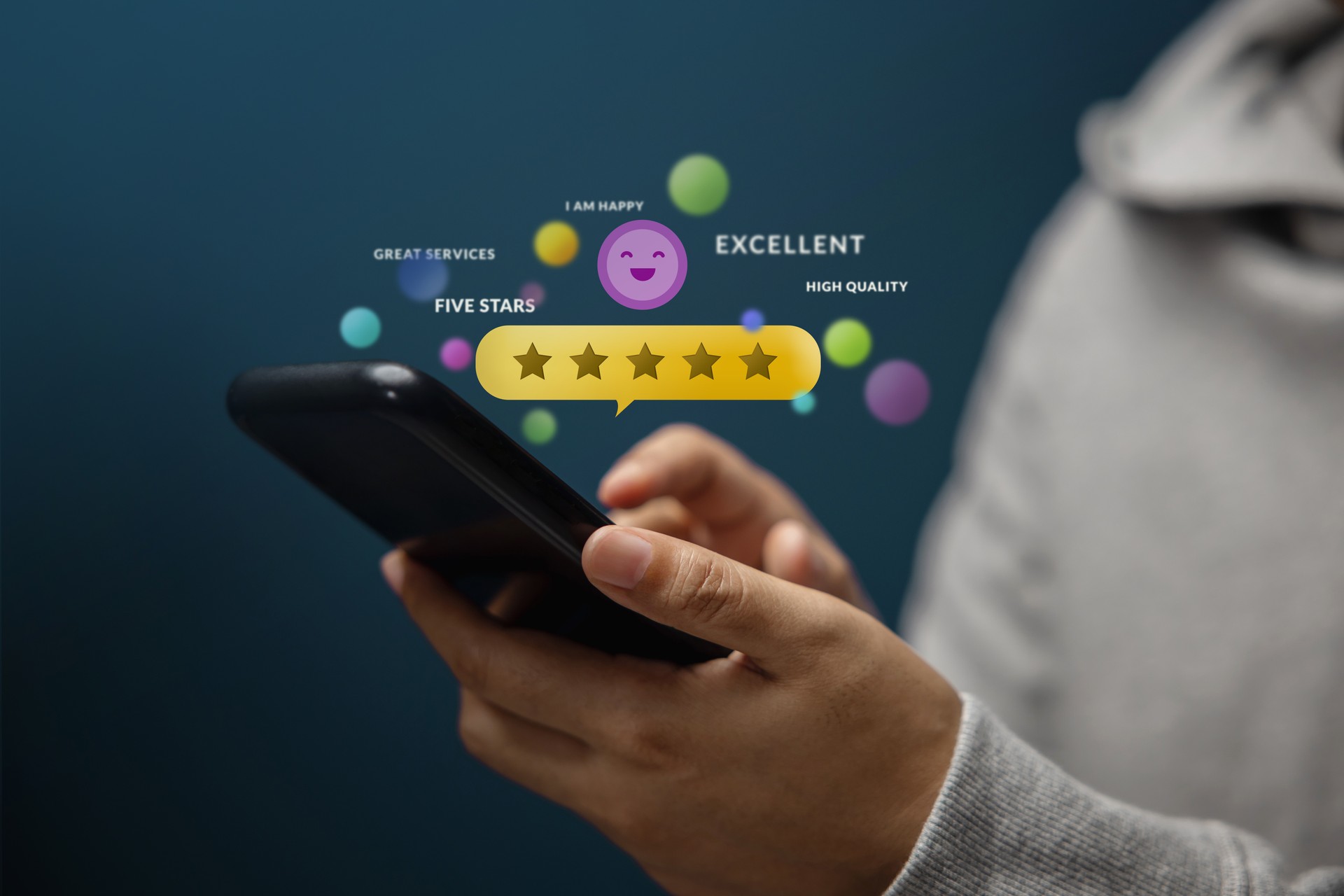 Customer Experiences Concept. Happy Client Using Smartphone to Review Five Star Rating for Online Satisfaction Surveys. Positive Feedback on Mobile Phone