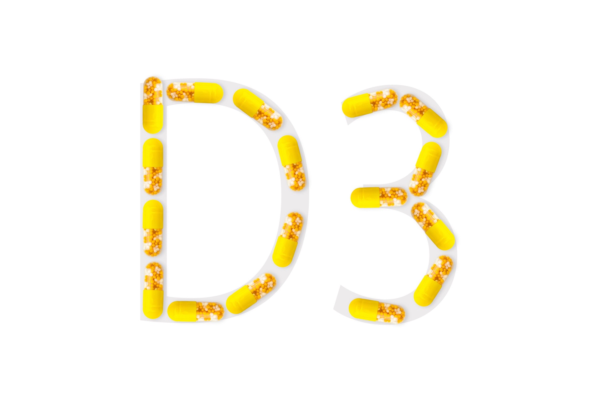 Yellow capsules forming shape D3 on white background, Vitamin D3 concept