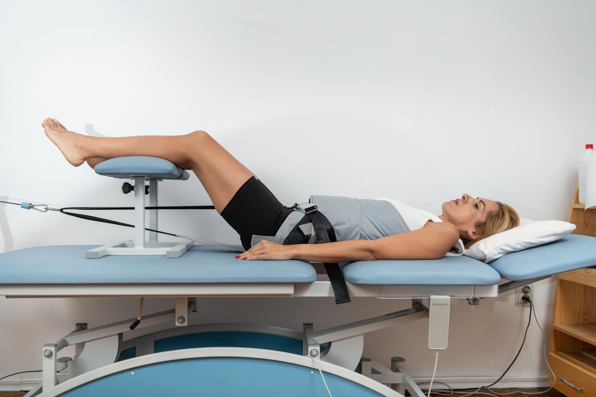 Mechanical traction is used to relieve back pain and stiffness by gently stretching the spine, reducing pressure on spinal discs, and promoting better mobility and recovery